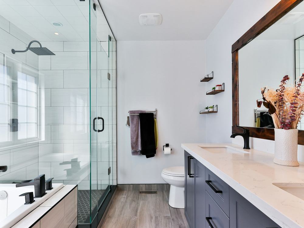 Newly remodeled bathroom with a glass shower and double vanity